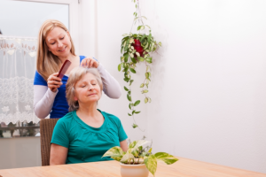 caregiver combing her patient hair