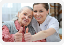 a nurse and an old woman showing their thumbs up